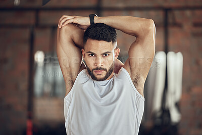 Buy stock photo Man, portrait and stretching arm in studio for warm up, daily workout routine and fitness for muscle development. Male person, serious and flexing for physical cardio, training or exercise for health