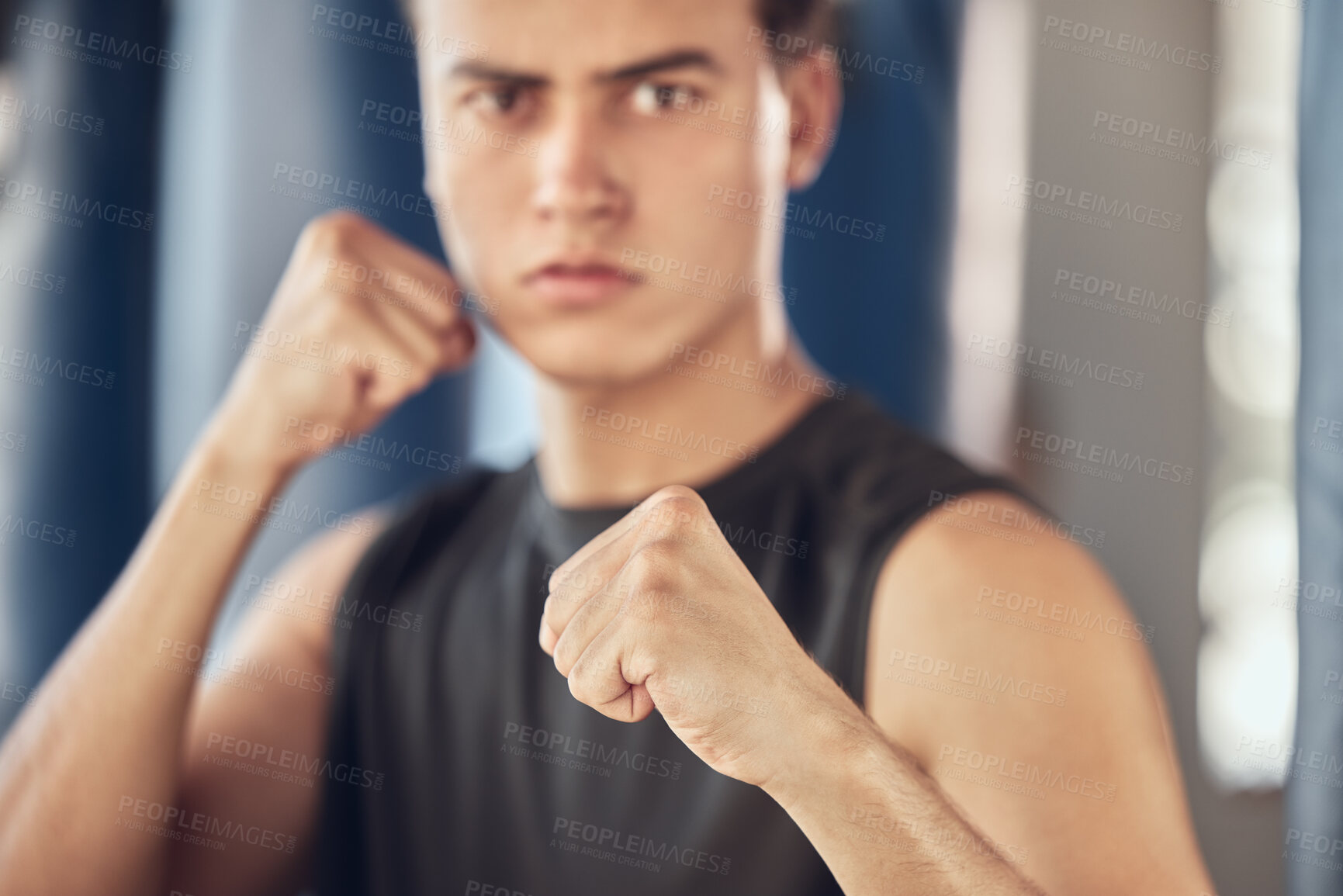 Buy stock photo Man, portrait and hands in fist in gym for fighting tournament, boxing match and training for competition. Male person, serious and ready for challenge or sport, self defense and mma performance.