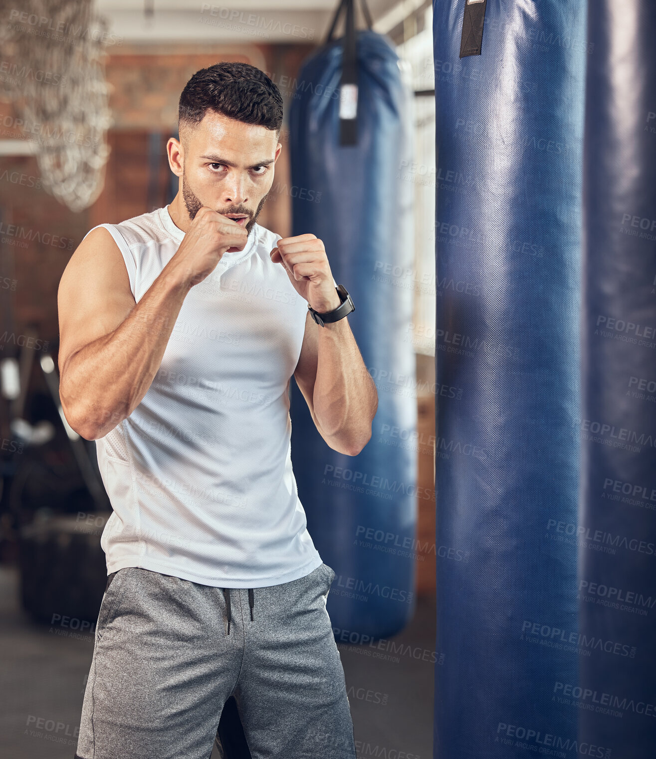 Buy stock photo Man, portrait and fist for boxing in gym for fighting tournament, match or training for competition. Male person, serious and ready for challenge or sport, self defense and mma performance or workout