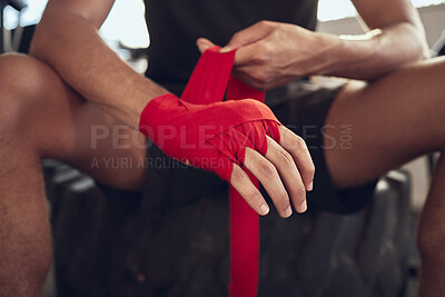 Buy stock photo Man, boxer and wrapping knuckles with bandage for self defense, fight or workout at indoor gym. Closeup of active male person or fighter with strap on hands for boxing safety, protection or gloves