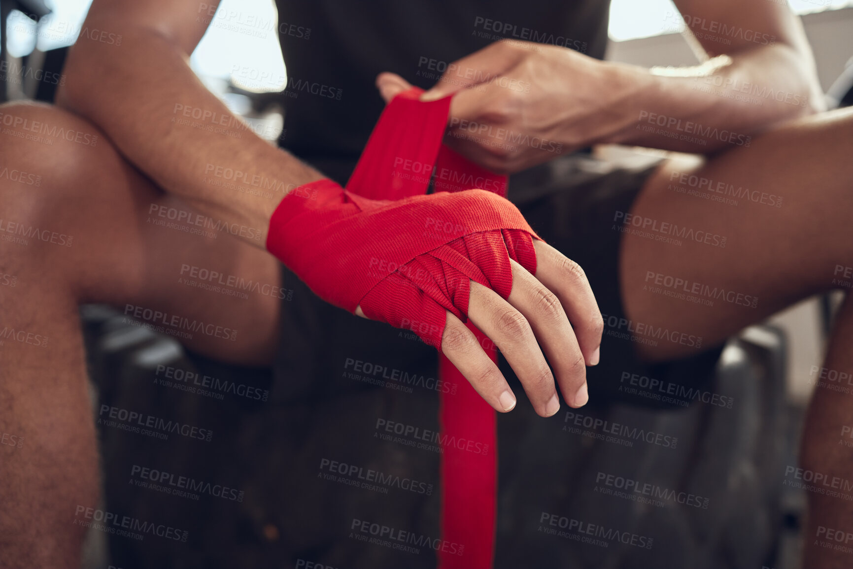 Buy stock photo Man, boxer and wrapping knuckles with bandage for self defense, fight or workout at indoor gym. Closeup of active male person or fighter with strap on hands for boxing safety, protection or gloves