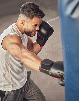 Buy stock photo Man, boxer and punching bag with boxing gloves for training, combat practice or self defense at gym. Male person, athlete or fighter with strike or attack in fitness for martial arts at health club