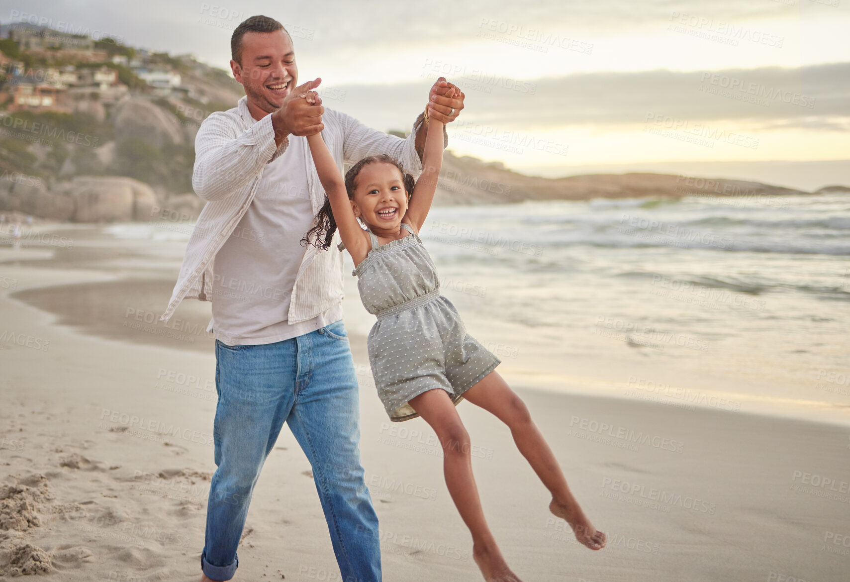 Buy stock photo Beach, happy and father swing child on vacation, adventure or getaway together for bonding by sea. Smile, fun and dad lifting girl kid by ocean on holiday or weekend trip with connection and energy.