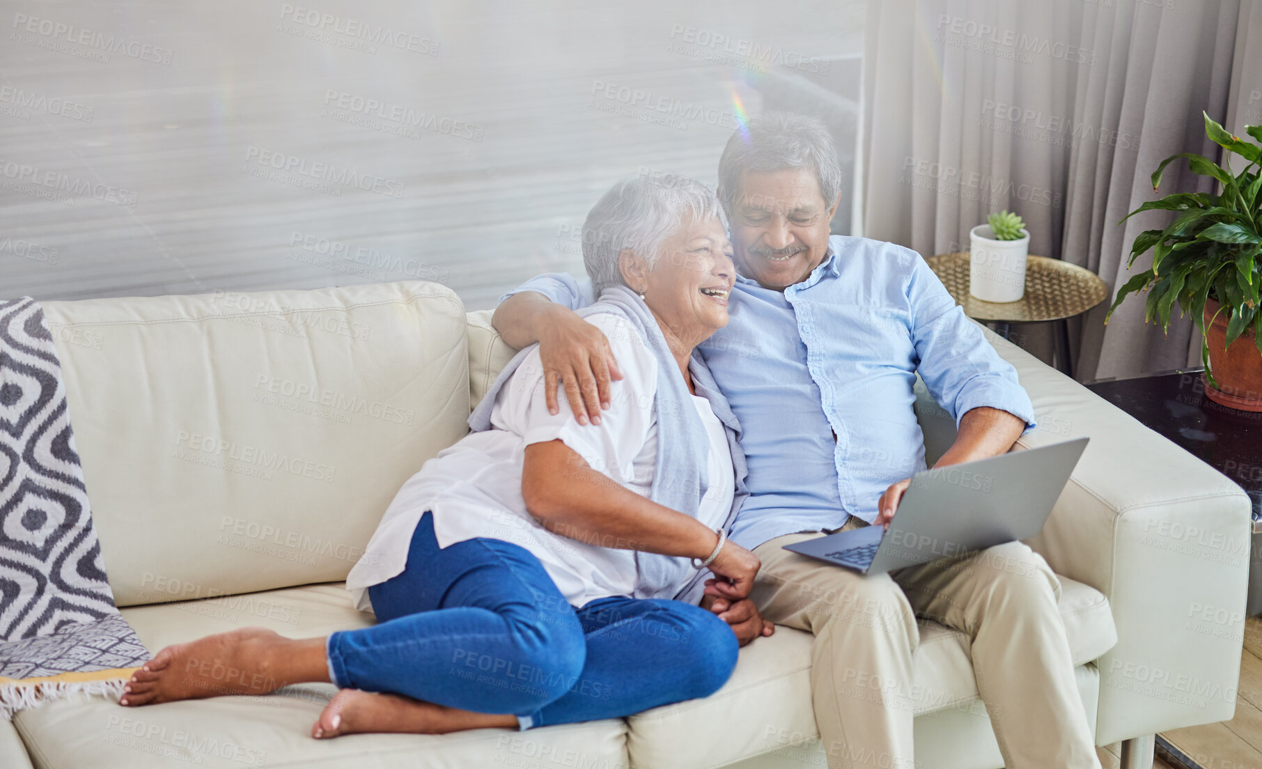 Buy stock photo Senior couple, hug and sofa with laptop for bonding, entertainment or online browsing together at home. Mature man and woman with smile in embrace on couch or computer for holiday or weekend at house