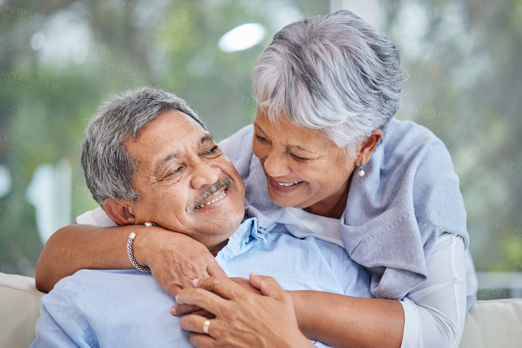 Buy stock photo Hug, love and marriage with senior couple on sofa of home living room together for bonding. Embrace, relax or wellness with elderly man and woman in apartment for relationship, retirement or romance