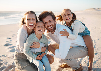 Buy stock photo Parents, kids and hug at beach, portrait and smile for love, excited or bonding on holiday in summer. Father, mother and daughter children on ground, laugh or connection in sunshine by ocean in Spain