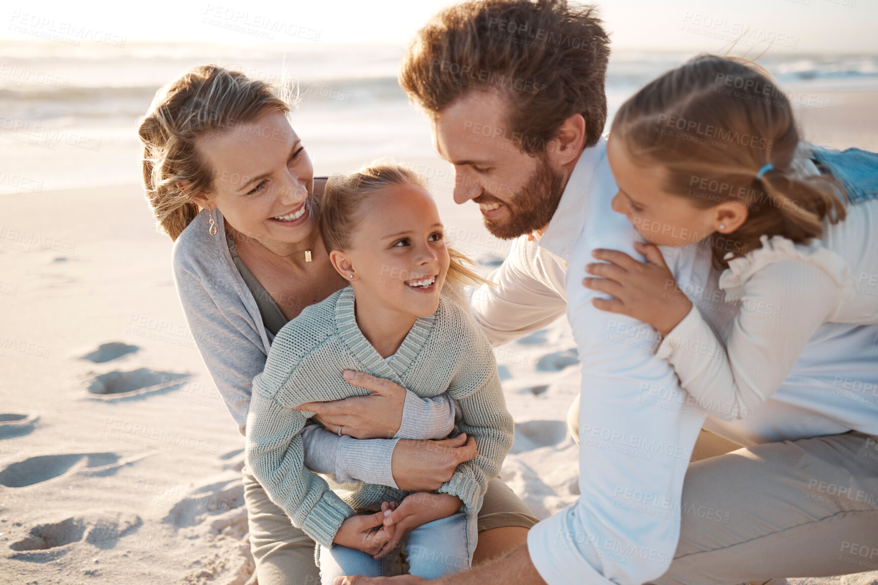 Buy stock photo Fun, love and smile with family on beach together for holiday, travel or vacation in summer. Nature, sand or wind with mom, dad and daughter children outdoor on coast by ocean or sea for bonding