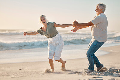 Buy stock photo Old couple, holding hands and playing on beach for love, travel and sea waves for retirement. Senior people, marriage and holiday for laughing by water, happy and silly wife on weekend vacation