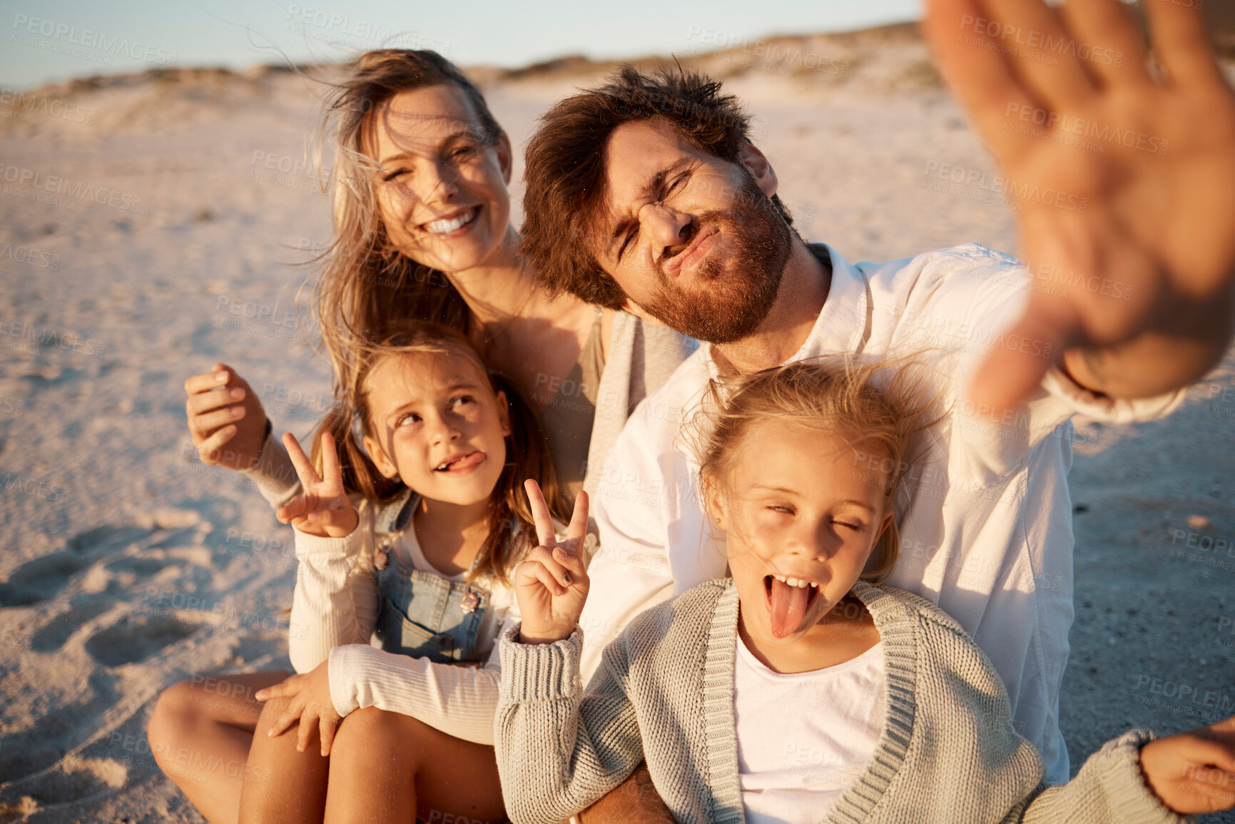 Buy stock photo Parents, children and selfie at beach, funny face or smile with care, love or tongue out for memory in summer. Father, mother and daughter kids with peace sign, family or portrait on holiday in Spain