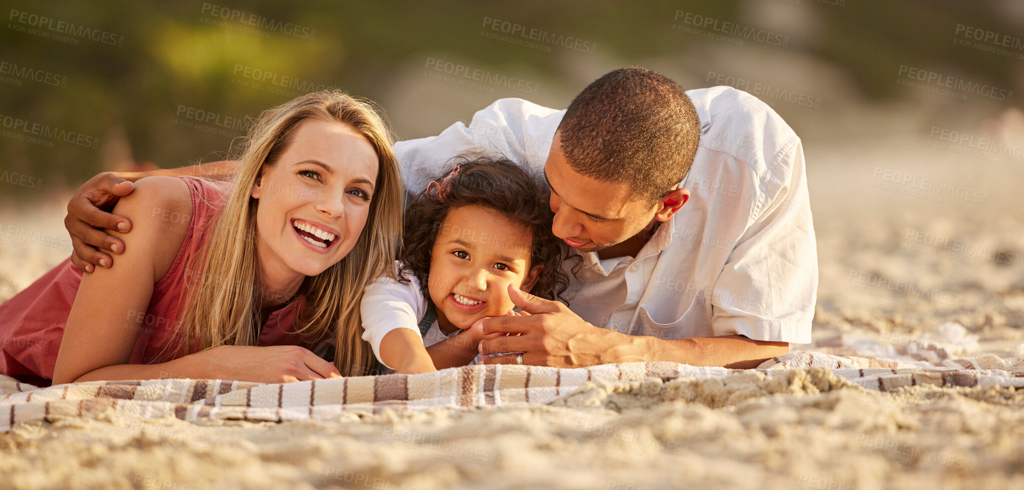 Buy stock photo Portrait, child and parents on beach as happy family for love, support or care on vacation or holiday. Woman, man and interracial in bonding with kid, outdoor and together for affection, joy or relax