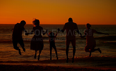 Buy stock photo Family, people and happy with jump at beach for bonding on break, relax and fun in Spain. Holding hands, back and playful on silhouette at ocean on holiday with happiness for travel and adventure