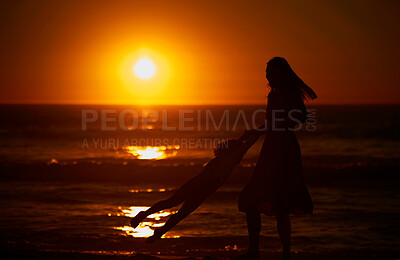 Buy stock photo Mom, kid and happy with swing at beach for bonding on break, relax and fun in Spain. People, family and playful on silhouette at ocean on holiday with smile for child development, growth and care