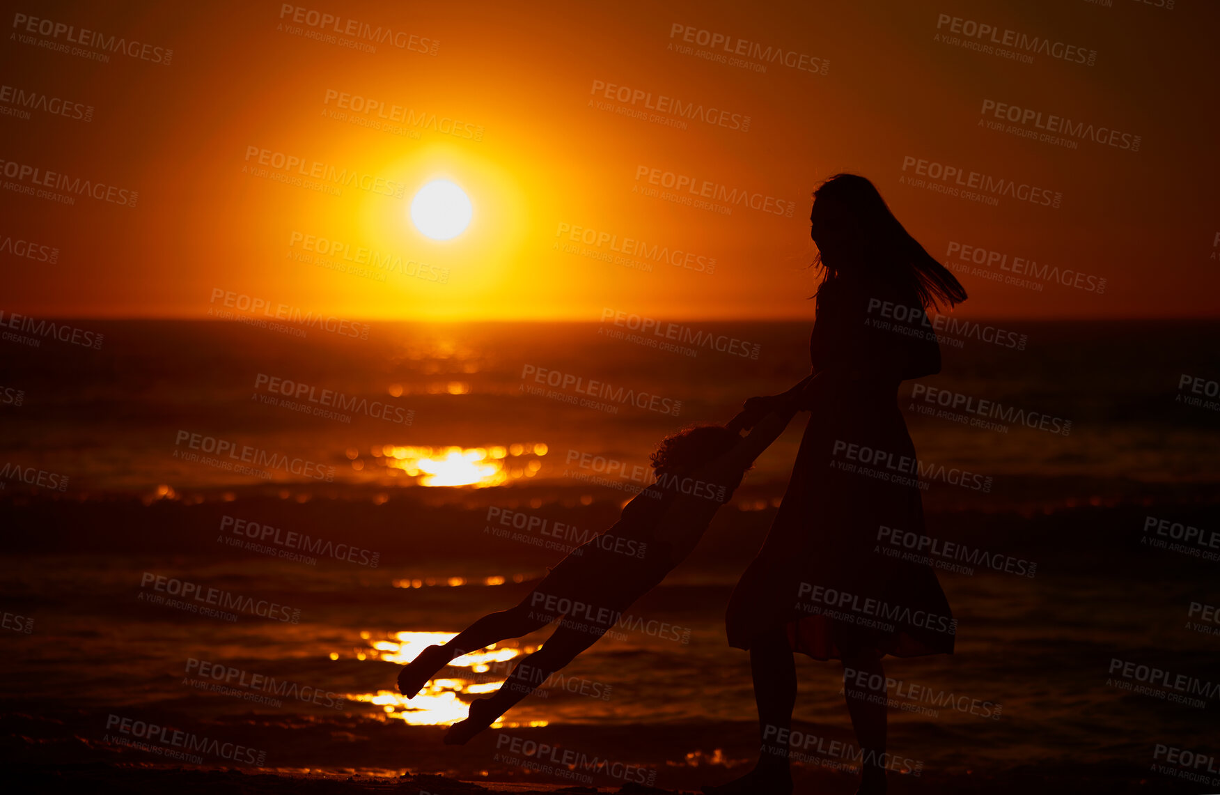 Buy stock photo Mom, kid and happy with swing at beach for bonding on break, relax and fun in Spain. People, family and playful on silhouette at ocean on holiday with smile for child development, growth and care