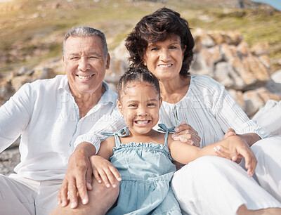 Buy stock photo Outdoor, portrait and grandparents on vacation, beach and grandma with granddaughter, bonding or love. Happy, old man and girl with mature people, sea and relax in holiday, travel or break with child