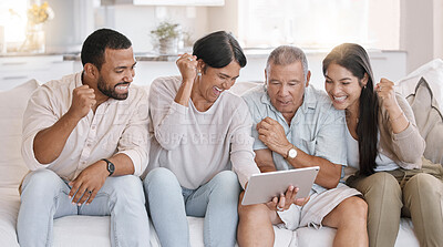 Buy stock photo Fist pump, smile and tablet with family on sofa in living room of home together for cheering or success. Celebration, happy or streaming with senior parents, man and woman sports fans in apartment