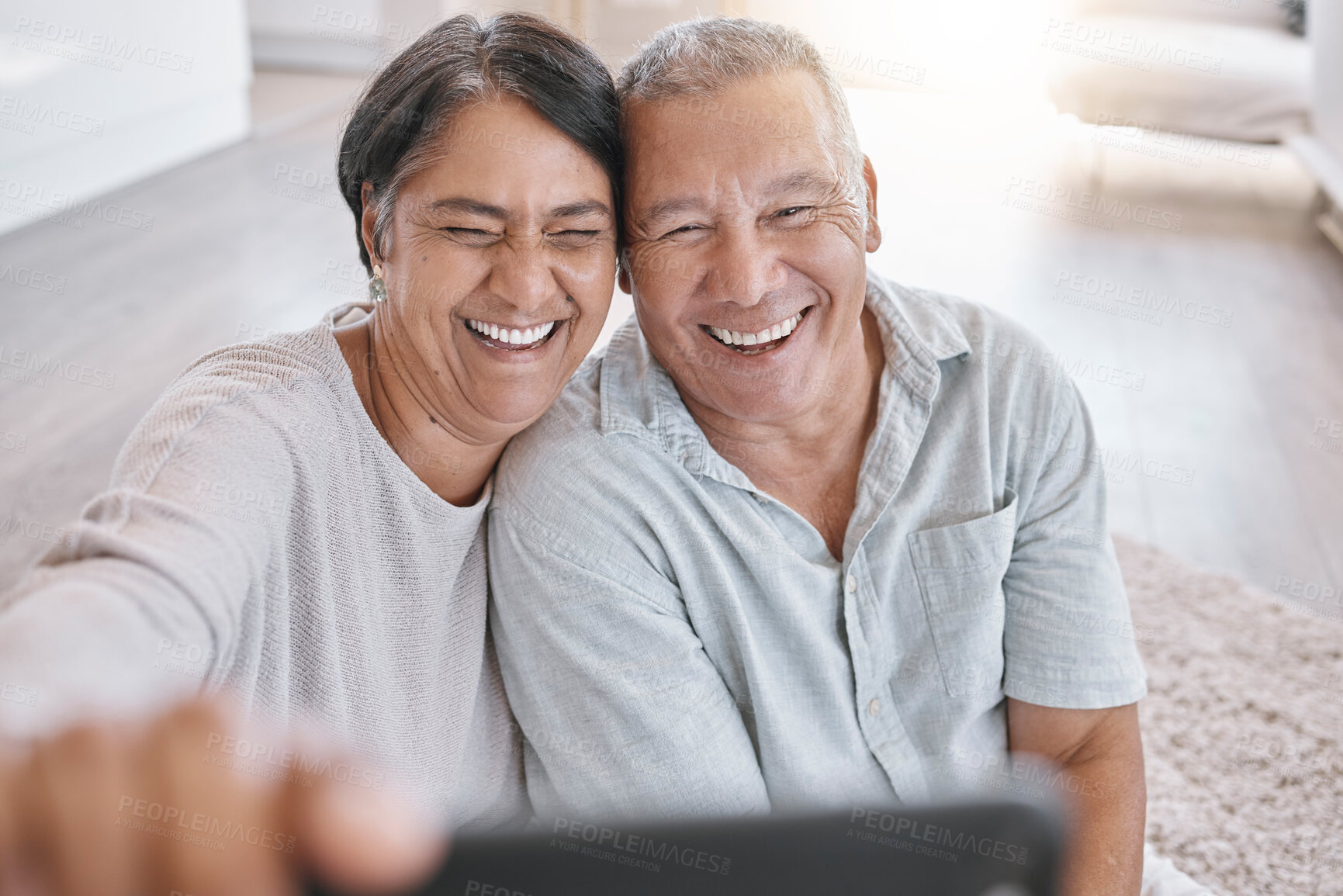 Buy stock photo Senior couple, selfie and happy in home for love, relax and comfort in retirement. Smile, elderly people and close in living room for photography, affection and tech for live stream or video call