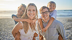 Portrait of a happy caucasian family standing together on the beach. Loving parents spending time with their two children during family vacation by the beach