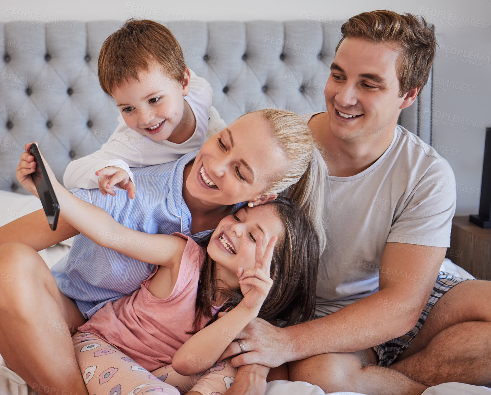 Buy stock photo Happy family, selfie and parents with children in bedroom for photo, memory or v hand gesture on social media. Picture, mom or dad with siblings for connection, love or people with peace sign in home