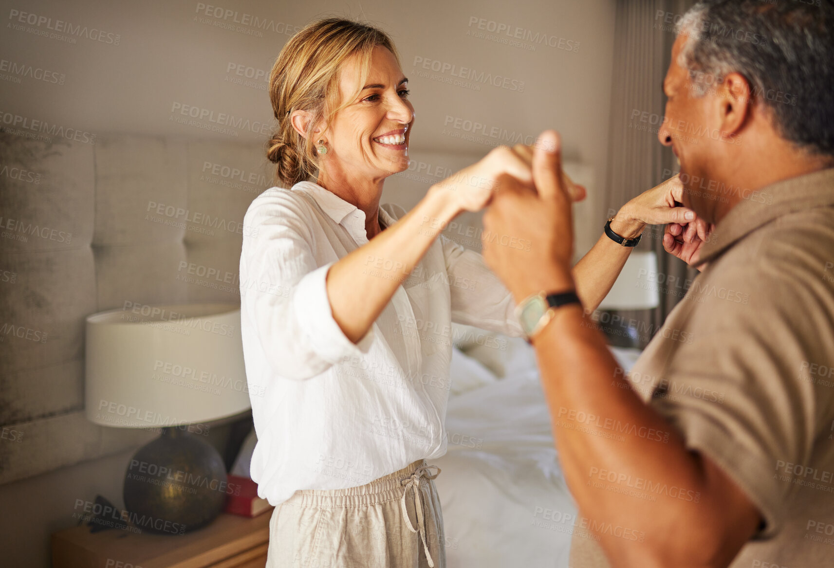 Buy stock photo Dance, holding hands and smile with mature couple in bedroom of home together for bonding or love. Anniversary, music or relax with husband and wife in apartment for fun, security or wellness