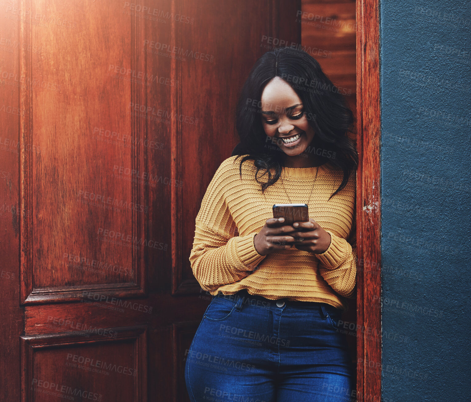 Buy stock photo Black woman, phone and smile with social media, text and post graduate study break at library. University, campus and African student with app for networking for scholarship application by door