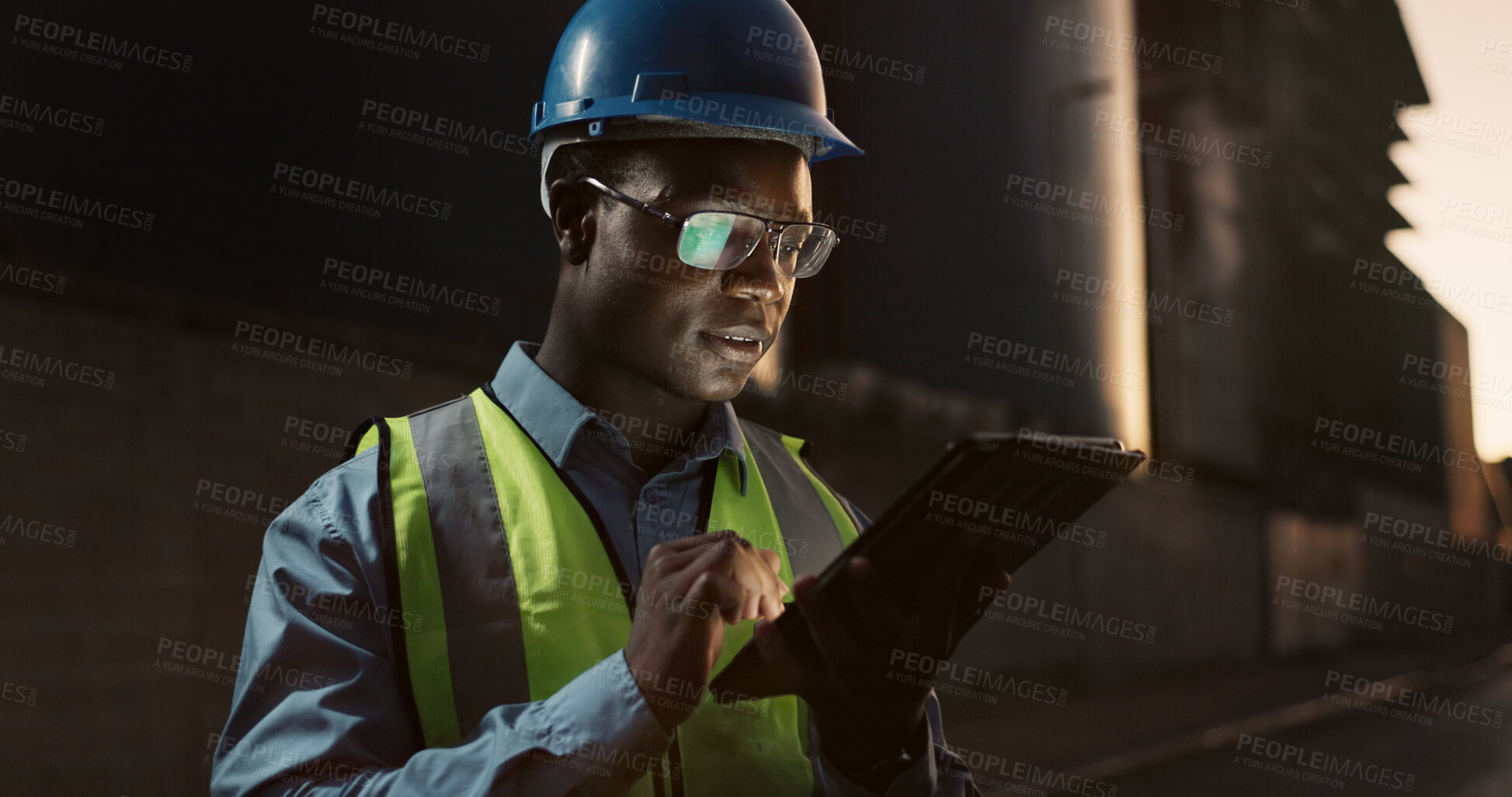 Buy stock photo Construction site, night and black man on tablet in city for planning, building or maintenance. Civil engineering, architecture and person on digital tech for project, infrastructure or manufacturing