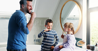 Buy stock photo Dad, bathroom and brushing teeth with children in home for morning routine, dental hygiene and oral health. Father, siblings and teaching with toothbrush for cleaning mouth, bonding and wellness.