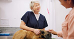 Mature, doctor and dog with woman in clinic checkup, hospital and veterinary healthcare and veterinarian professional. Animal care, pet owner and happy for good diagnosis, puppy wellness and help