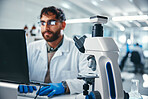 Laptop, microscope and science with man in laboratory for development, innovation or research. Computer, online study and pharmaceuticals with scientist at work on medical breakthrough or discovery