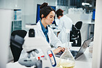 Laptop, woman and medical scientist in laboratory with online research for cancer clinical trial. Science, computer and female biologist with pharmaceutical discovery for healthcare innovation.