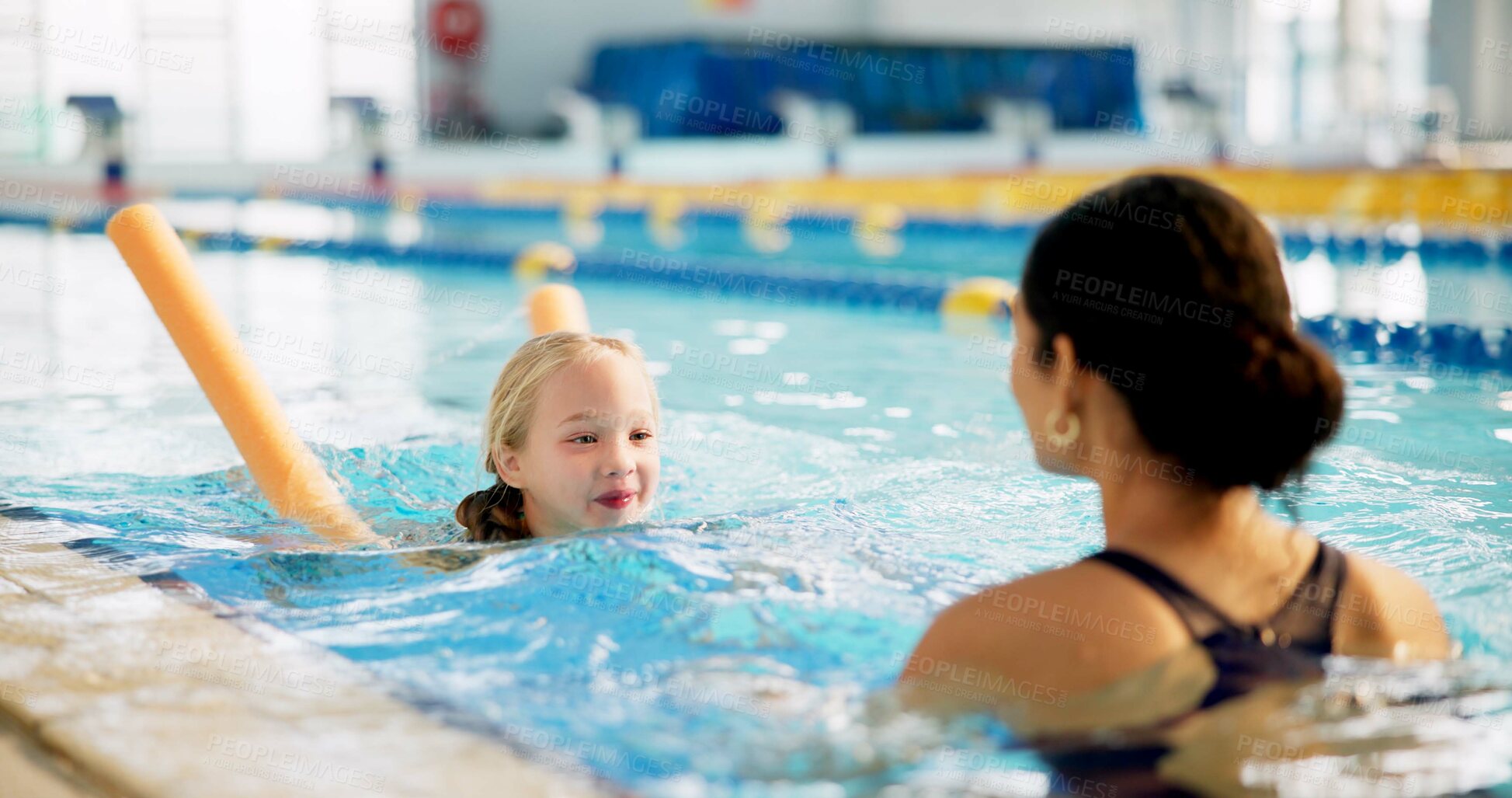 Buy stock photo Instructor, active and girl in pool, swimming and woman with smile, proud and helping child in water. Lesson, happy and learning with teacher in school for training of kid, sports and teaching