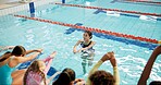 Swimming pool, woman and kids with fitness, water and coach with safety, instructions and teaching. People, trainer and students with recreation, learning and specialist with conversation and expert