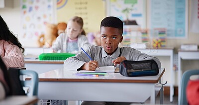 Buy stock photo Boy, child and writing notes in classroom for learning, knowledge and info for assessment. Kid, notebook and education with scholarship, studying and attention at lesson for development at school