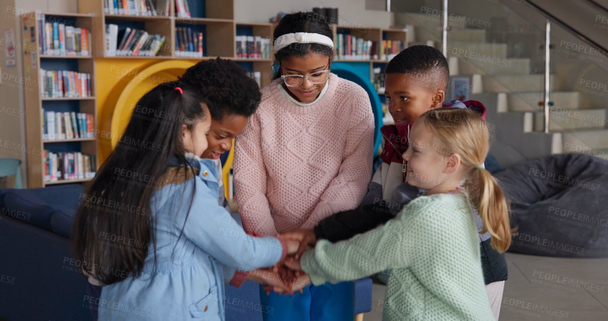 Buy stock photo Students, library and hands together for unity in school with fun game, teamwork and solidarity in education. Children, friends or piling activity for team building, celebration and study achievement