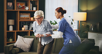 Buy stock photo Senior woman, nurse and patient with walking stick for support, care or assistance by sofa at home. Female person or caregiver helping elderly with cane by living room couch in physiotherapy at house