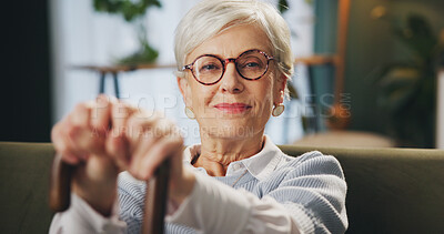 Buy stock photo Cane, portrait and senior woman with disability at home, arthritis and happiness in retirement. House, elderly lady and hands with walking stick for balance, vertigo disease and osteoporosis on sofa