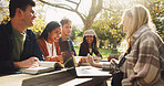 Group, happy and friends to studying outdoor on school break, discussion and laughing of funny joke in summer. Smile, people and students with laptop, books and education for bonding together at park