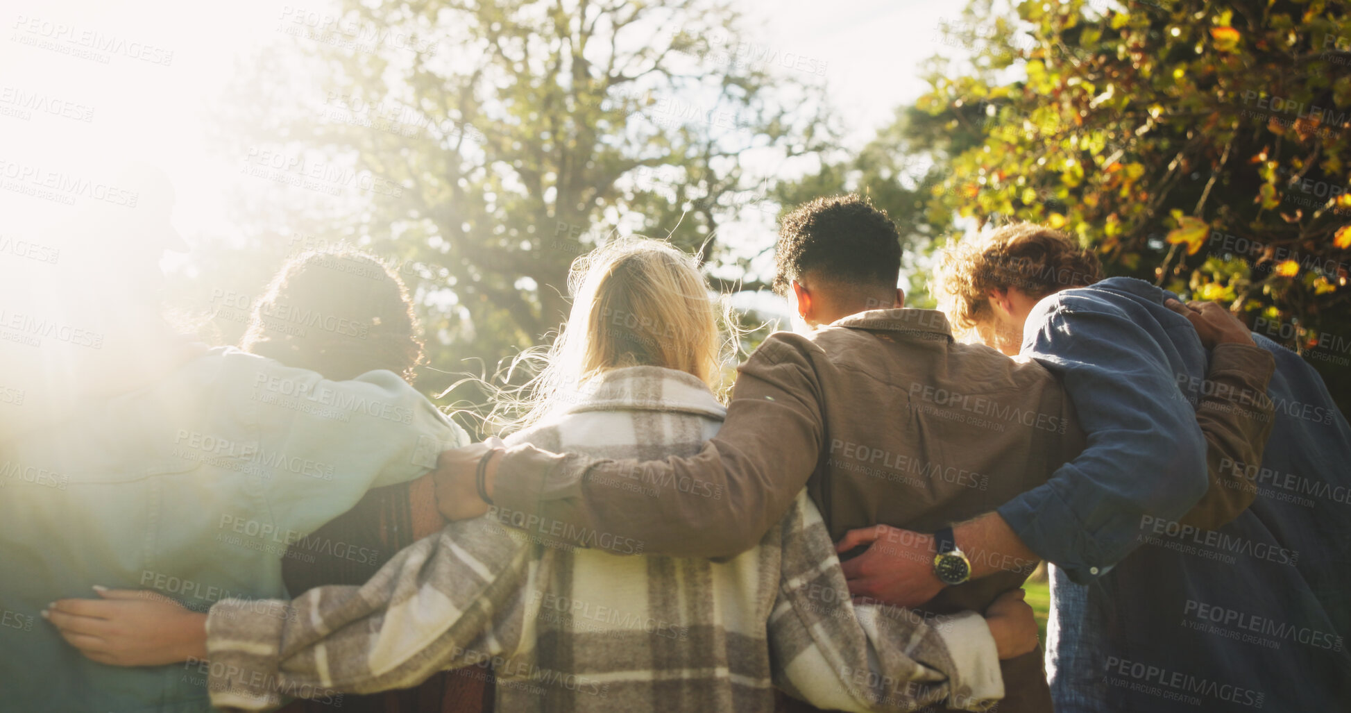 Buy stock photo Group, back and friends to relax outdoor on school break, lens flare and hug for bonding in summer. People, students and embrace with support, care and trust together for social reunion at park