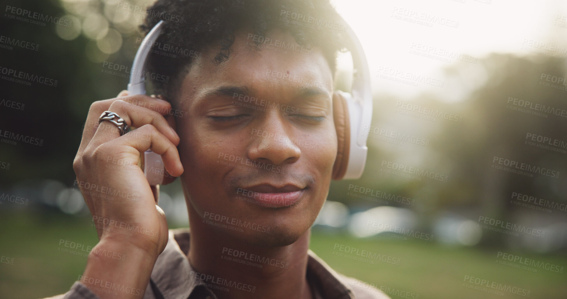 Buy stock photo Outdoor, headphones and man listening to music, break and calm with podcast, radio and happiness. Nature, person and guy in park, headset and streaming for sound, audio and peace with wellness