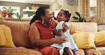 Smile, grandmother and hug child at house for bonding, love and care together of family support on sofa. Happy, black woman and girl with embrace for funny joke, comic meme and retirement in lounge