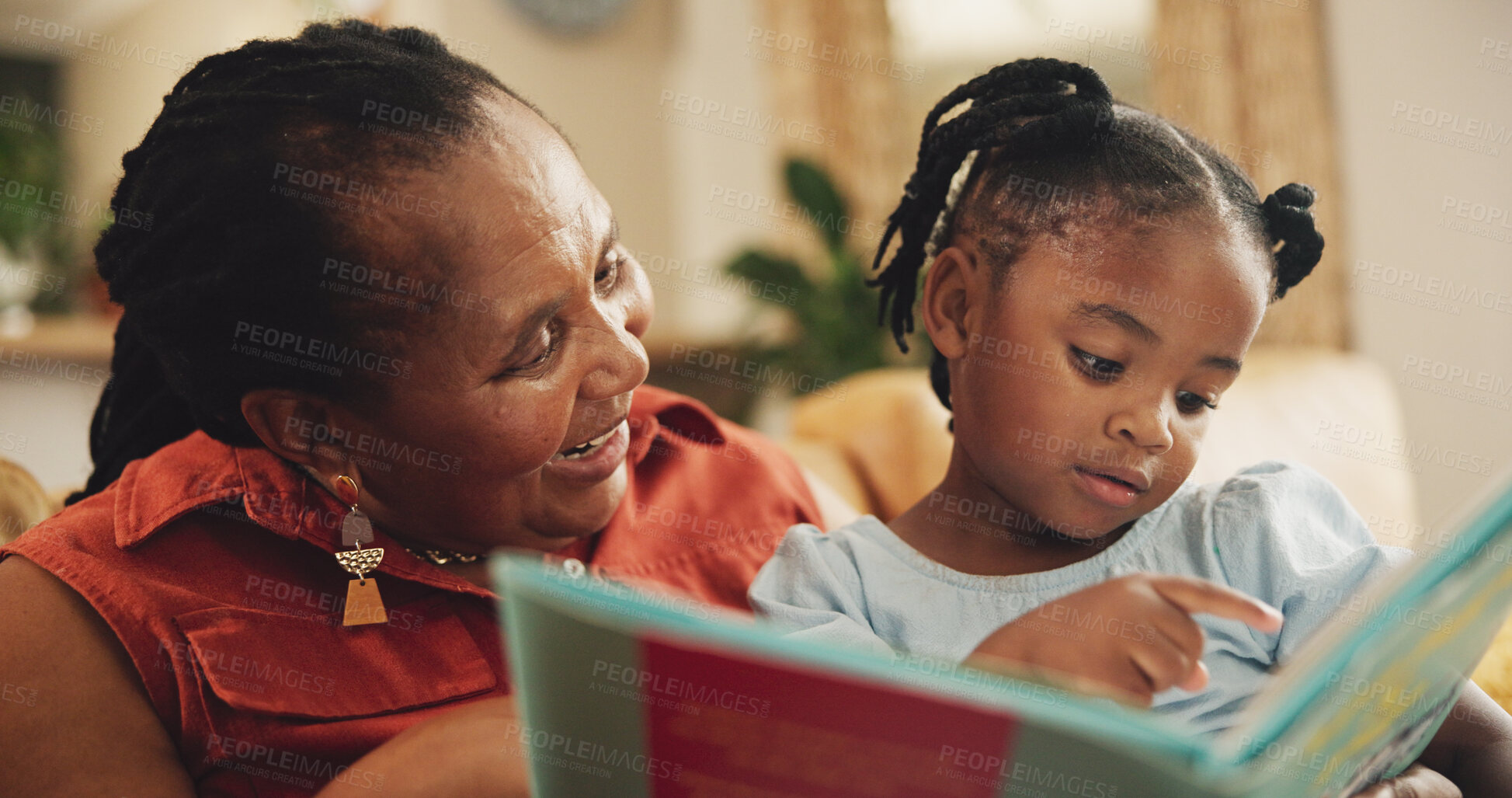 Buy stock photo Smile, grandmother and child with book for education, learning literature and fantasy storytelling in lounge. Black family, woman and girl with creative reading, support and language growth at house