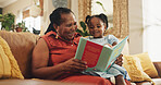 Grandmother, child and reading book for education with smile, learning literature and fantasy storytelling. Black family, woman and girl with creative knowledge, support and language growth at house