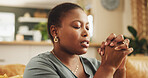 Praying, faith and black woman in home for worship, praise and hope for spirituality. Belief, religion and African female person with prayer for healing, gratitude or peace with guidance at house.