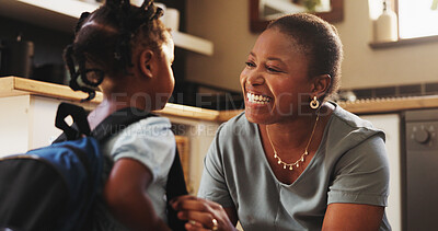 Buy stock photo African woman, child and backpack for school, education, morning and support for childhood development. Mother, daughter and excited with smile, care and love in kitchen or home for bonding as family