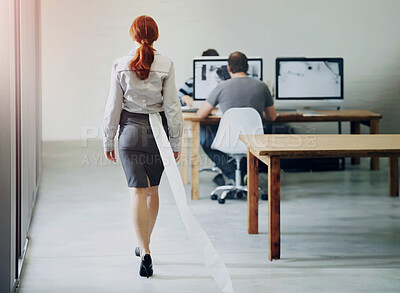 Buy stock photo A redheaded businesswoman walking back to her desk with toilet paper stuck in her skirt