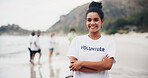 Girl, portrait and volunteer at beach for cleaning, recycling and environment sustainability with smile. Woman, ngo and crossed arms by ocean for community service, charity and pollution cleanup