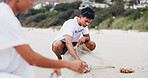 Man, volunteer and cleaning on beach for environment care, recycling and social responsibility. People, NGO drive and trash in nature for Earth Day, support and collaboration for go green at ocean