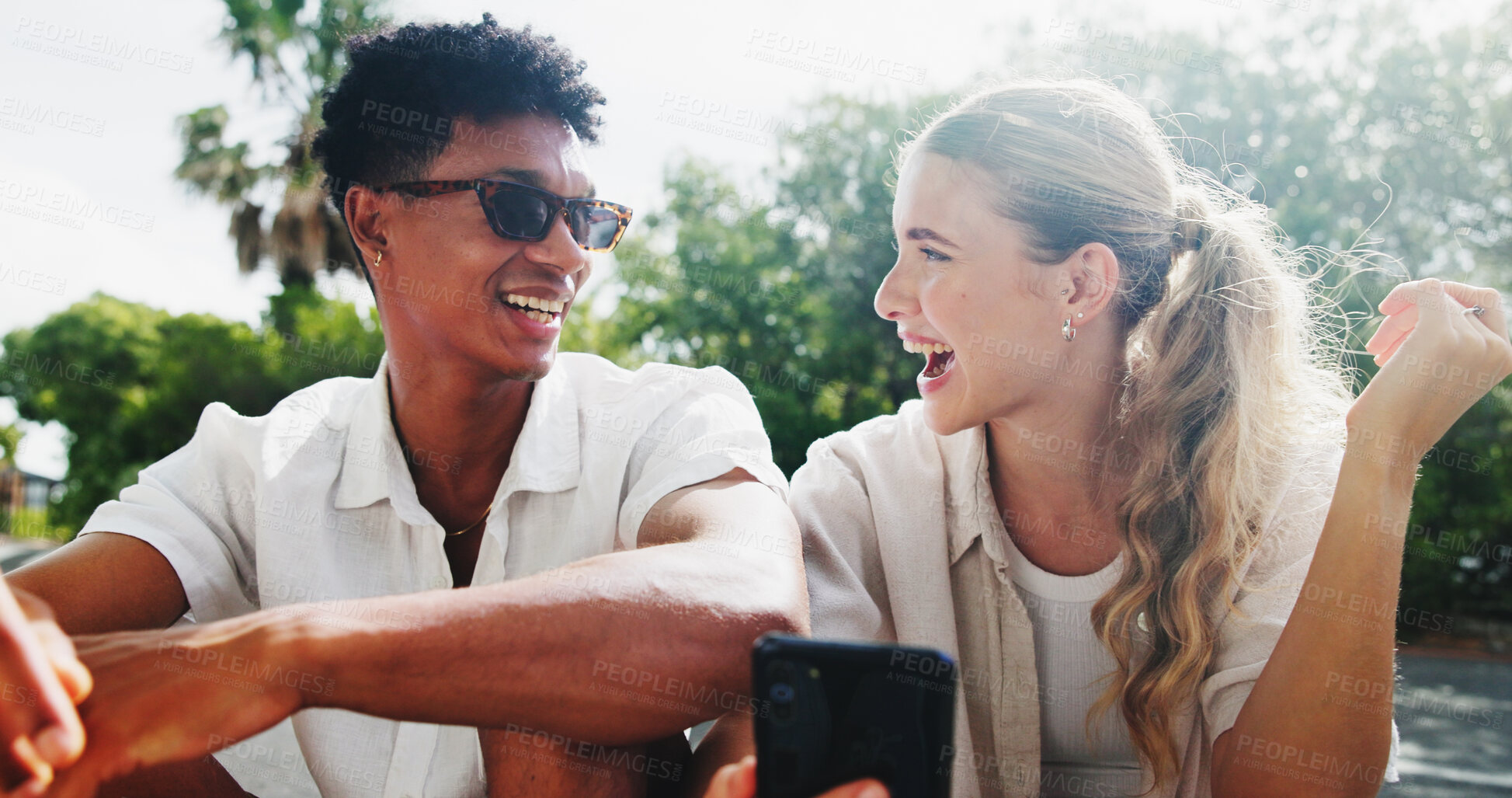 Buy stock photo Couple, people and happy outdoor with smartphone on browsing social media for entertainment in London. Relationship, love and smile in street for text notification with networking or communication