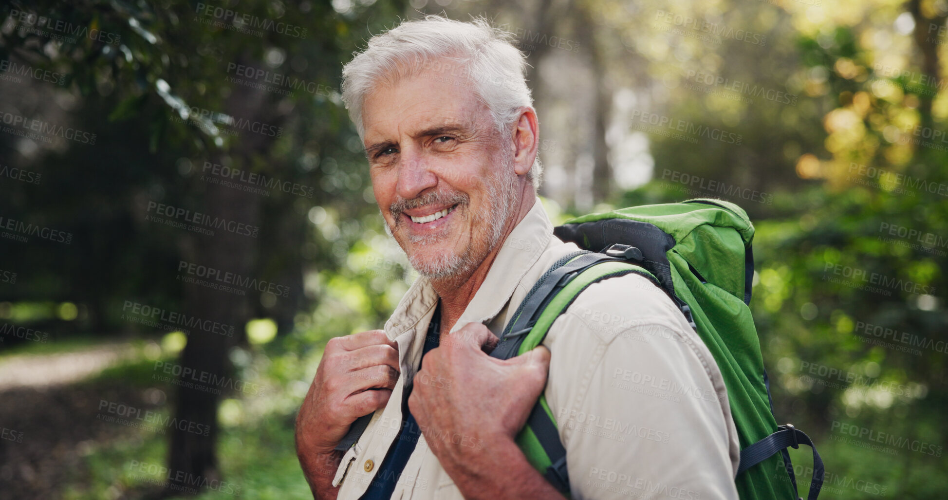 Buy stock photo Hiking, mature man and portrait in forest for fitness adventure, retirement hobby and wellness cardio. Senior, person and happy with backpack for trekking, explore and holiday sightseeing in woods