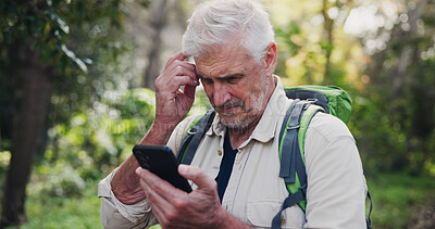 Buy stock photo Thinking, phone and mature man in nature for directions, navigation app and checking route. Lost, low signal and ecologist in woods with mobile, connectivity and location tracking error in wilderness