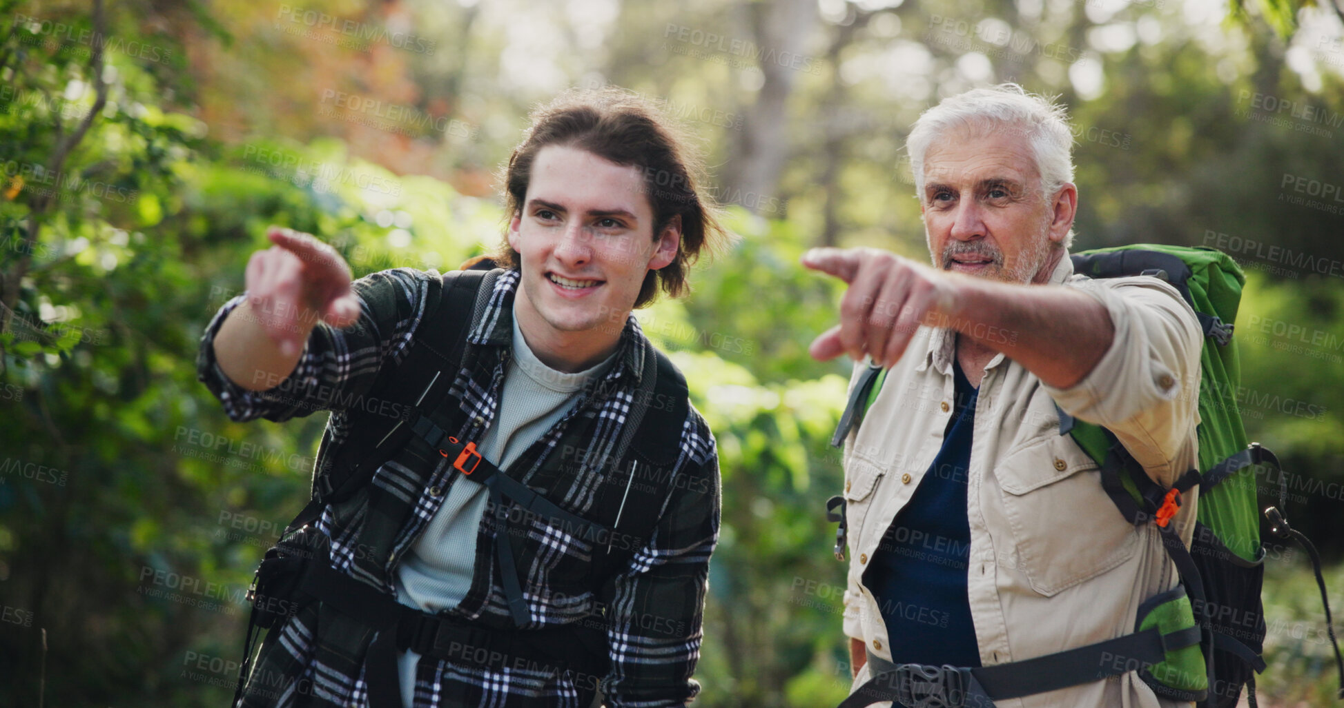 Buy stock photo Hiking, mature man and son in forest, outdoor and backpacking in nature for adventure, fitness or pointing. Journey, travel and old person on vacation in New Zealand, sightseeing or happy for holiday